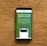 A smartphone displaying an advertisement for an online trading platform called eToro. The screen shows a green background with text promoting the platform as a leading social trading platform. A button labeled 'Get Started' is visible, along with a partial view of a mobile app screen below.